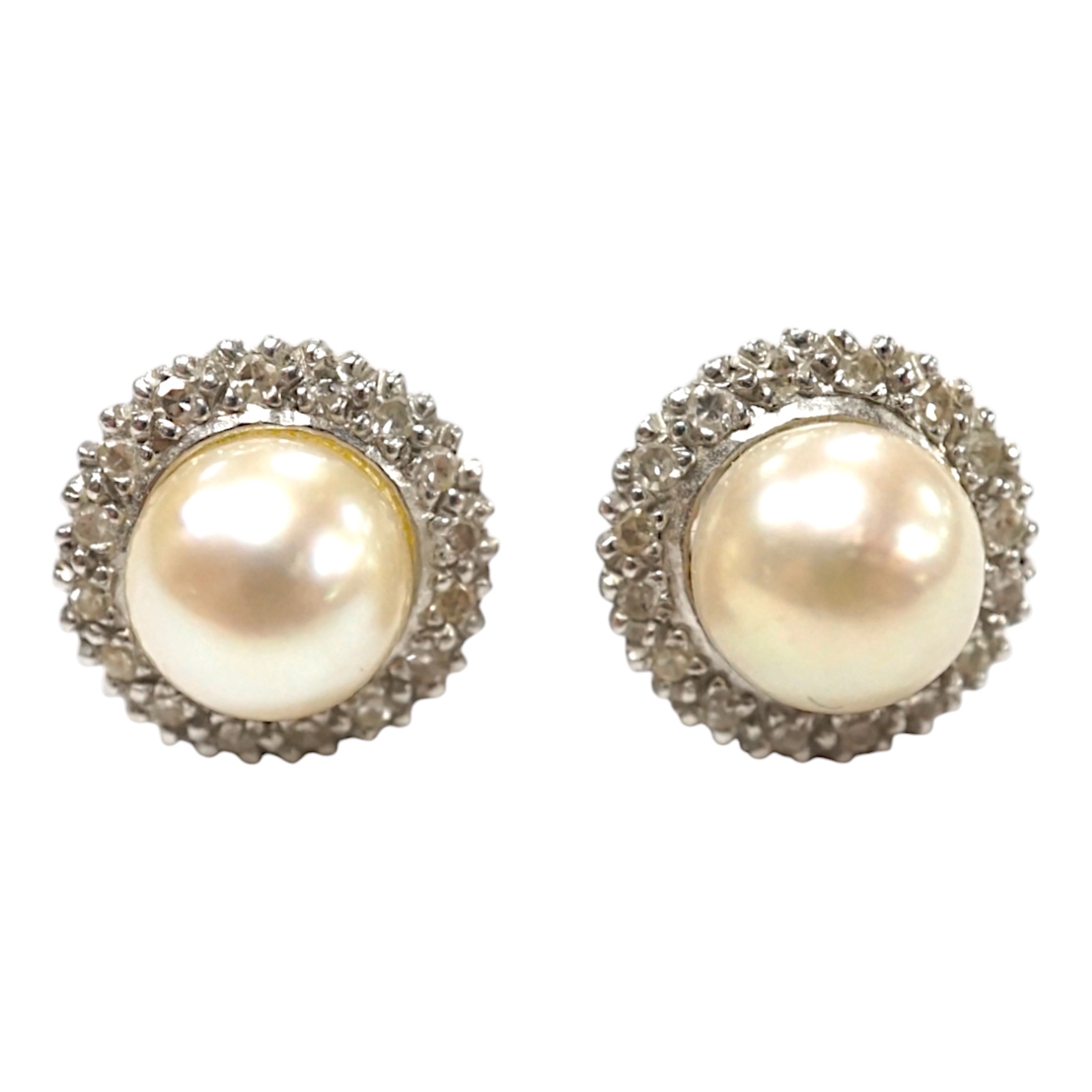 A pair of white metal cultured pearl and diamond cluster set ear studs, 10mm, gross weight 3.6 grams. Condition - fair to good